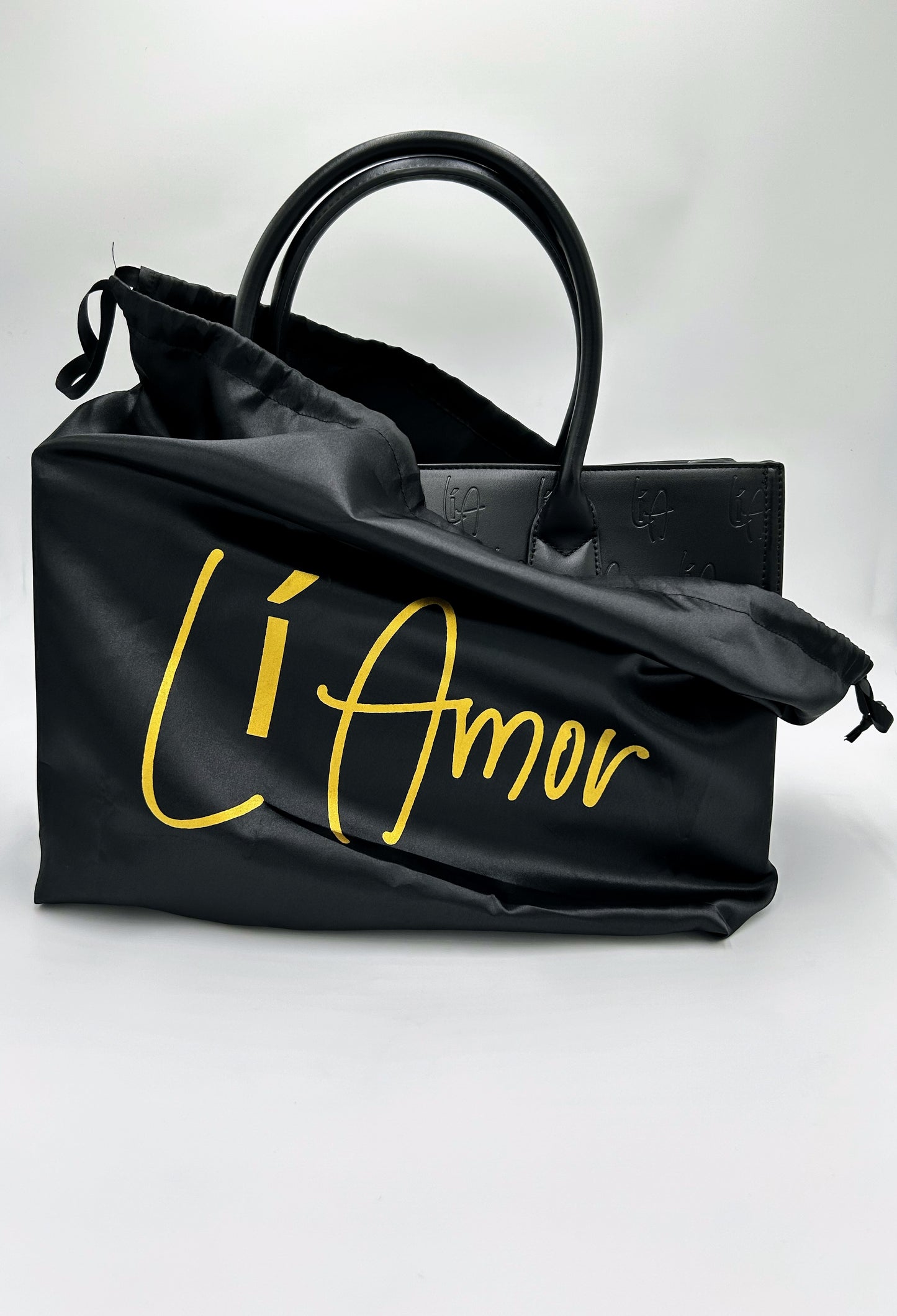 Li Amor black BOSS Bag with a black satin dust bag that has the Li Amor logo