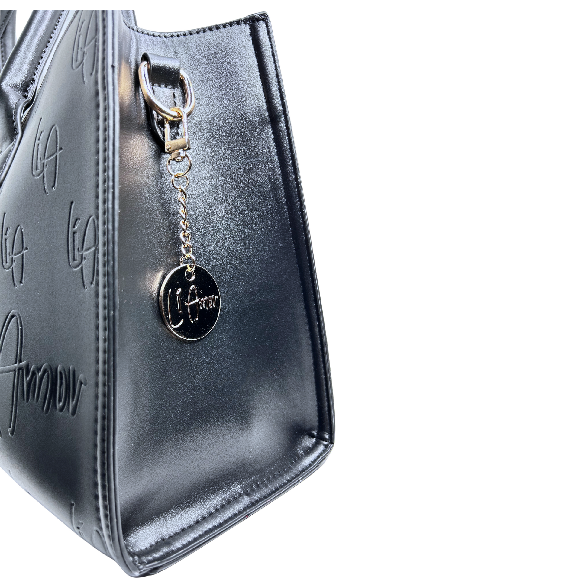 Li Amor black vegan leather messenger handbag with the Li Amor gold, circle purse charm. Side view of the purse