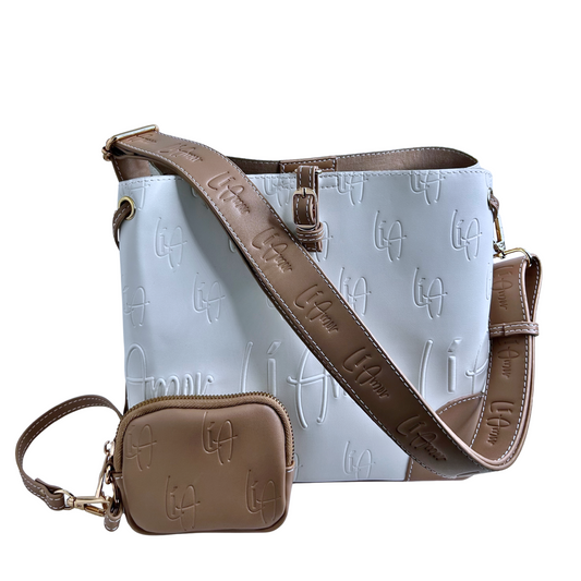 Li Amor white and beige Butter Me Up bucket bag/handbag/crossbody bag with a wide Li Amor shoulder strap and matching coin purse. The set has gold hardware.