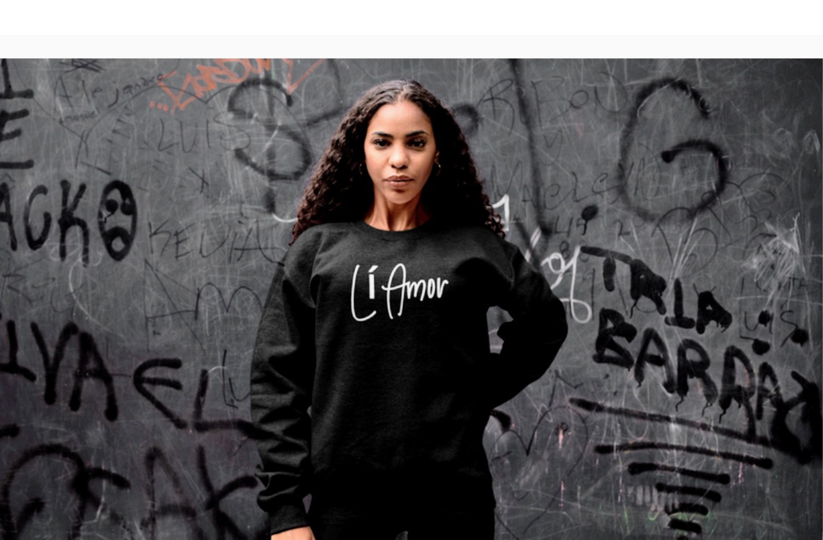 Model wearing a black Li Amor Crewneck Sweatshirt with the white Li Amor logo across the chest.